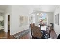Bright dining room featuring a chandelier, large windows, and stylish decor at 11059 E Kilarea Ave, Mesa, AZ 85209