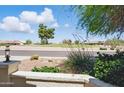 Inviting front porch area overlooking a serene neighborhood street and lush greenery at 11059 E Kilarea Ave, Mesa, AZ 85209