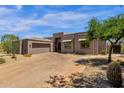 Stunning exterior view of a contemporary home with a spacious driveway and desert-friendly landscaping at 11123 E Monument Dr, Scottsdale, AZ 85262