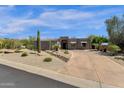 Contemporary home exterior with desert landscaping and a unique architectural design with inviting curb appeal at 11123 E Monument Dr, Scottsdale, AZ 85262