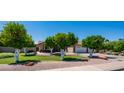 Charming home featuring lush green lawn, mature trees, and manicured landscaping enhancing its curb appeal at 1532 N Ogden --, Mesa, AZ 85205