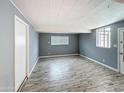 Versatile flex space features wood-style flooring, natural light, and neutral paint, perfect for any use at 1553 E Flower Cir, Mesa, AZ 85204