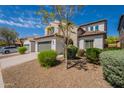 Attractive two-story home with a two-car garage and a meticulously maintained xeriscaped front yard at 1634 W Red Bird Rd, Phoenix, AZ 85085