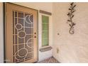 Close up of the front door with security screen and stylish decor elements at 1634 W Red Bird Rd, Phoenix, AZ 85085