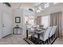 Bright dining room featuring tile floors, high ceilings, modern furniture, and plenty of natural light at 17224 N Zuni Trl, Surprise, AZ 85374