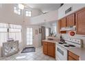 Well-lit kitchen boasts tiled floors, white appliances, and a convenient layout perfect for cooking at 17224 N Zuni Trl, Surprise, AZ 85374