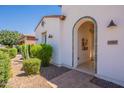 Welcoming front entrance with decorative tile archway, desert landscaping, and stylish outdoor lighting at 1787 E Sattoo Way, Queen Creek, AZ 85140