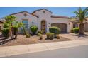 Inviting single-story home showcasing desert landscaping, an arched entryway, and a two-car garage at 1787 E Sattoo Way, Queen Creek, AZ 85140