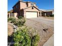 Inviting two-story home featuring a covered porch, a neutral color palette and an attached two car garage at 1810 N Mcdonald St, Casa Grande, AZ 85122