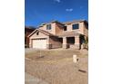 Inviting two-story home featuring a covered porch, a neutral color palette and an attached two car garage at 1810 N Mcdonald St, Casa Grande, AZ 85122