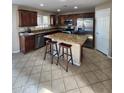 Well-equipped kitchen featuring stainless steel appliances, granite counters, and a central island with breakfast bar seating at 1810 N Mcdonald St, Casa Grande, AZ 85122