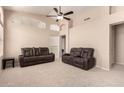 Spacious living room featuring neutral walls and carpet flooring, accompanied by vaulted ceilings at 18221 N 49Th Pkwy, Glendale, AZ 85308