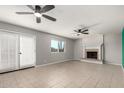 Spacious living room with a fireplace, ceiling fans, and sliding doors at 1829 E Decatur St, Mesa, AZ 85203
