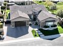 Striking aerial view of home with manicured landscaping and paver driveway, situated on a golf course at 2351 E Cherrywood Pl, Chandler, AZ 85249