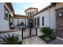 Charming front entrance with decorative iron gate, stone accents, and manicured landscaping at 2351 E Cherrywood Pl, Chandler, AZ 85249
