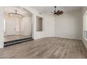 Spacious living area featuring modern lighting, two steps and beautiful flooring at 2552 E Silverwood Dr, Phoenix, AZ 85048