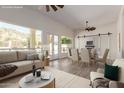 Staged living room with a view of the fireplace and backyard swimming pool at 2552 E Silverwood Dr, Phoenix, AZ 85048