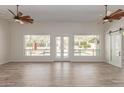 Bright living room boasts expansive windows overlooking the refreshing backyard pool at 2552 E Silverwood Dr, Phoenix, AZ 85048