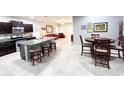 Spacious kitchen with granite countertops, dark cabinets, and a breakfast bar at 25935 W Potter Dr, Buckeye, AZ 85396
