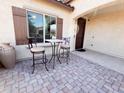Inviting front patio with stone pavers and seating area perfect for relaxing outdoors at 25935 W Potter Dr, Buckeye, AZ 85396