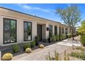 Inviting home entrance with potted plants, desert landscaping, and a stylish pathway at 26099 N 88Th Way, Scottsdale, AZ 85255