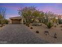 Charming home exterior features a desert landscape, paver driveway, and a two-car garage at 26099 N 88Th Way, Scottsdale, AZ 85255