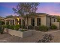 Beautiful home exterior featuring a stone planter and desert landscaping at 26099 N 88Th Way, Scottsdale, AZ 85255