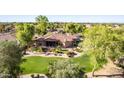 Aerial view of the backyard featuring desert landscaping, mature trees, and ample room for outdoor activities at 2641 E Birchwood Pl, Chandler, AZ 85249