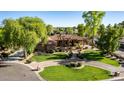 An inviting single-story home featuring lush landscaping, a circular driveway, and a grand entrance at 2641 E Birchwood Pl, Chandler, AZ 85249