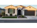 Charming single-story home featuring a tile roof, desert landscaping, and a two-car garage at 27636 W Runion Dr, Buckeye, AZ 85396