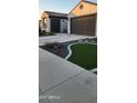Well-maintained home with manicured landscaping, a two-car garage, and a paved driveway at 27636 W Runion Dr, Buckeye, AZ 85396