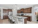 Modern kitchen features a large island with seating, granite countertops, and stainless steel appliances at 27636 W Runion Dr, Buckeye, AZ 85396