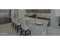 Beautiful kitchen island with granite countertops and seating for four at 27636 W Runion Dr, Buckeye, AZ 85396