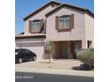 Charming two-story home with a two car garage, landscaped yard, and a neutral exterior at 284 W Settlers Trl, Casa Grande, AZ 85122