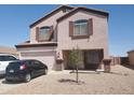 Charming two-story home with a two car garage, landscaped yard, and a neutral exterior at 284 W Settlers Trl, Casa Grande, AZ 85122