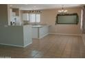 Bright kitchen features stainless steel appliances, ample counter space, and a cozy dining area at 284 W Settlers Trl, Casa Grande, AZ 85122