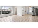 Bright living room with large windows and neutral tile floors at 2913 E Earll Dr, Phoenix, AZ 85016