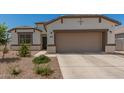 Charming single-Gathering home featuring a two-car garage and a low maintenance desert landscaped front yard at 37008 N Hinterwald Way, San Tan Valley, AZ 85143