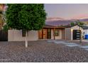 Attractive home with desert landscaping, modern front door, and a detached garage at 4205 N 19Th Pl, Phoenix, AZ 85016