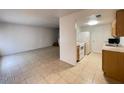 Bright living area with tile flooring leading into an open kitchen space at 4714 E Pueblo Ave, Phoenix, AZ 85040
