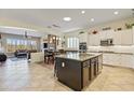Spacious kitchen featuring white cabinets, a dark island, granite countertops and stainless steel appliances at 5122 S Miller Pl, Chandler, AZ 85249