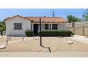Attractive single-story home featuring desert landscaping, a red tile roof, and a walkway to the front door at 541 W Vernon Ave, Phoenix, AZ 85003
