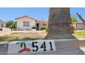 Charming home with desert landscaping and palm tree near the curb displaying address number at 541 W Vernon Ave, Phoenix, AZ 85003