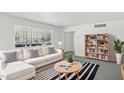 Bright living room features a large window, modern sofa, and stylish striped rug at 541 W Vernon Ave, Phoenix, AZ 85003