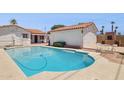 Backyard pool area with a red tile roof structure, a white brick wall and a classic outdoor brick fireplace at 541 W Vernon Ave, Phoenix, AZ 85003