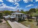 Charming two-story home with a balcony, spacious driveway, and well-maintained landscaping at 55 E Pierson St, Phoenix, AZ 85012