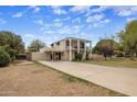 Spacious home with a long driveway and attached carport, featuring a second story balcony at 55 E Pierson St, Phoenix, AZ 85012
