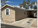 Single-story home with a covered parking area and a long concrete driveway at 625 W Mckellips Rd # 236, Mesa, AZ 85201