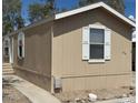 Angle showing the side and front of this single-story home with a covered parking area at 625 W Mckellips Rd # 236, Mesa, AZ 85201