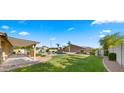 Beautifully landscaped backyard with a refreshing pool, a pergola, and plenty of green space at 6602 S Constellation Way, Gilbert, AZ 85298